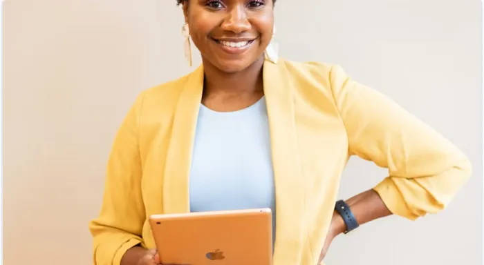 Amara Osei-Bonsu holding a tablet