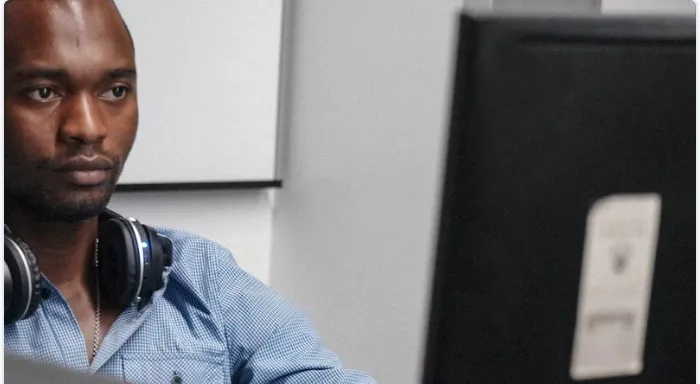 Sipho Ndlovu working at a computer workstation
